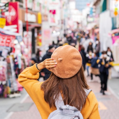 A girl walking into the colorful world of Harajuku's Takeshita St