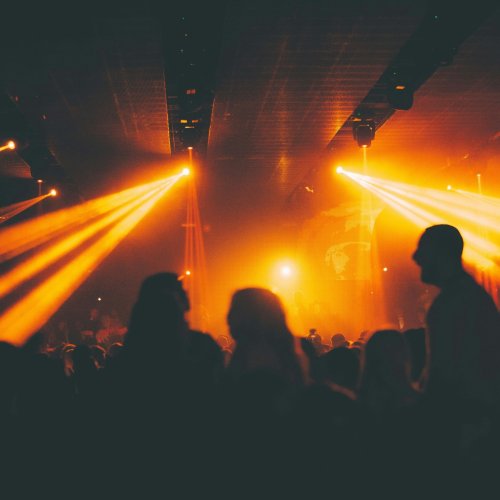 Spotlights at a club, lighting up the dancing crowds