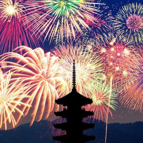 Fireworks illuminating a Japanese pagoda